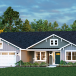 A modern, single-story house with gray siding, white trim, a dark roof, and a double garage—perfect for those seeking custom homes in North Central Florida. The front yard features green grass, shrubs, blooming flowers, and trees under a blue sky.