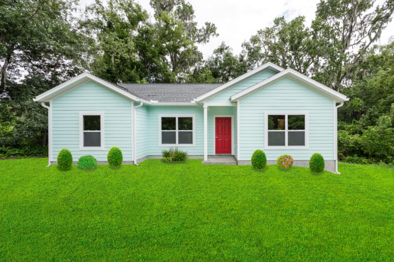 Blue house with red door custom built by Red Door Homes fl